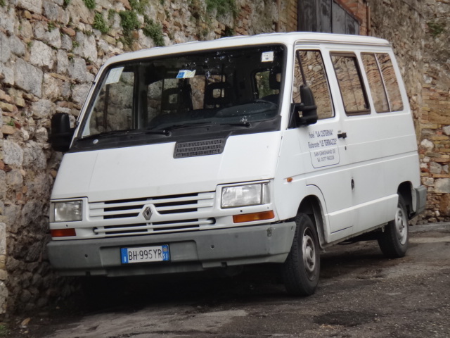 a van parked outside an old stone building