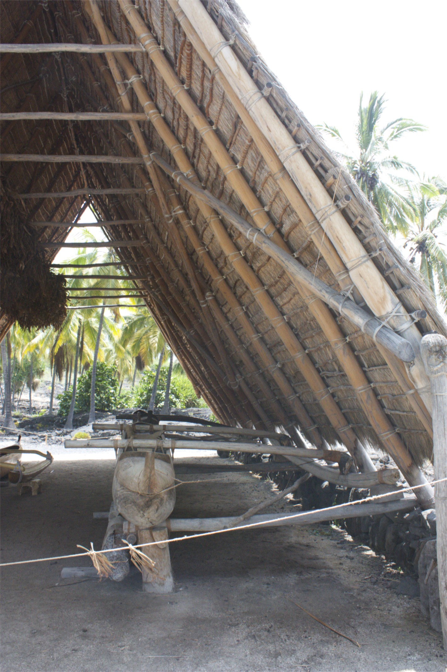 two men are working underneath a wooden structure