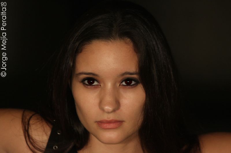 an image of woman with makeup on and dark background