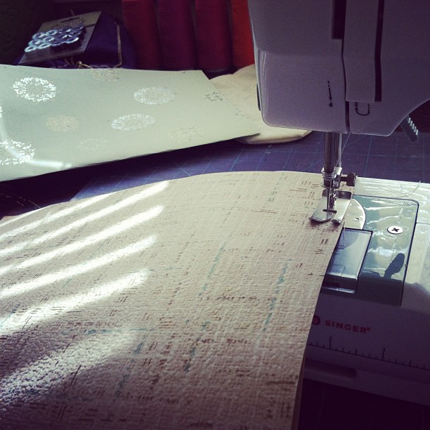 the fabric is being sewn in and a machine is working on it