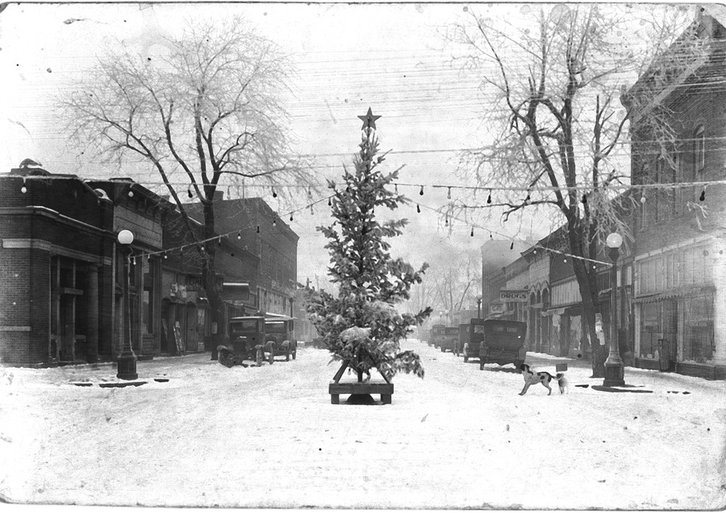 there is a christmas tree that is on the snowy street