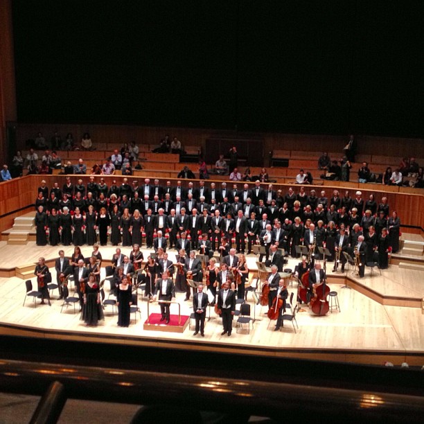 a concert scene with a conductor and orchestra