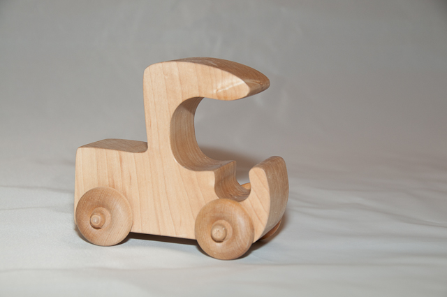 a wooden toy made to look like a car