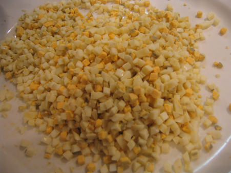 chopped corn on a white plate ready to be cooked