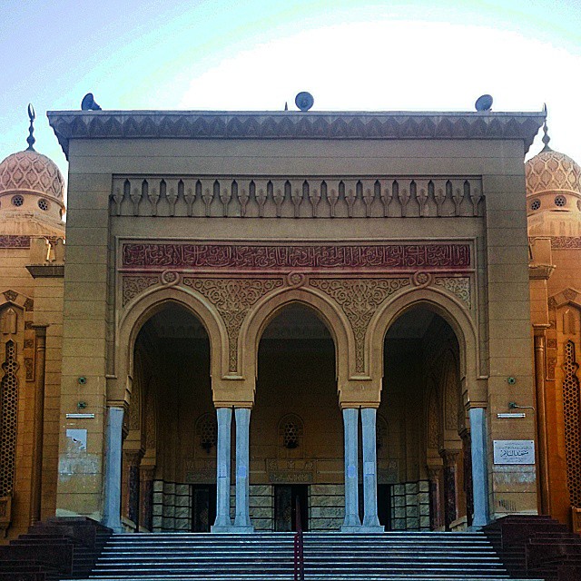 an ornate building with columns and steps on the side