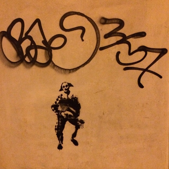 graffiti on the wall of a restaurant featuring a man with a guitar