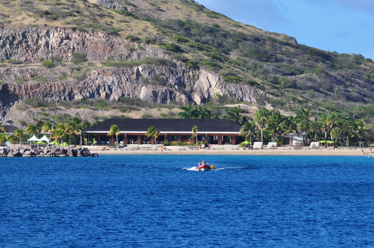 there is a boat in the water near a mountain