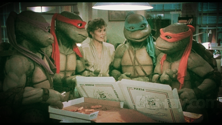 the cast of teenage mutant turtles looking at their pizzas