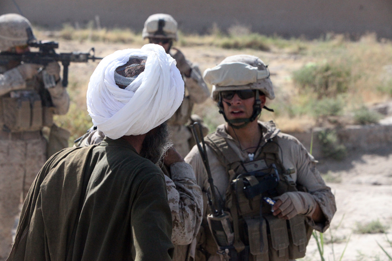 a group of men wearing military uniforms and holding rifles