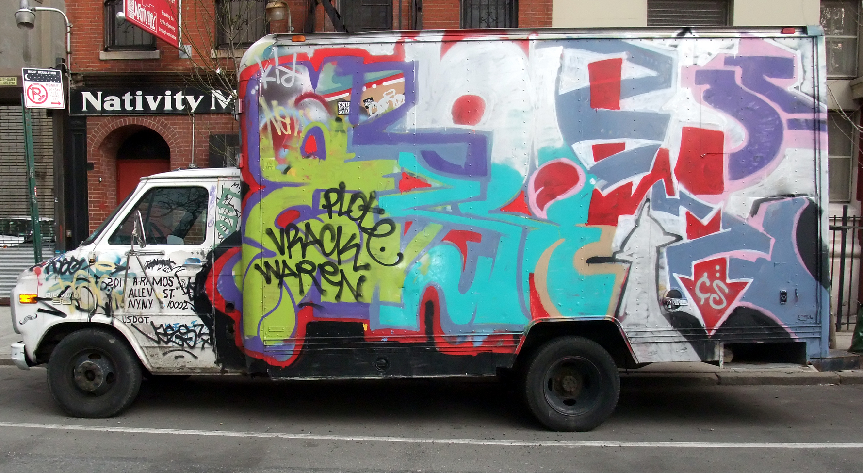 truck with graffiti all over the side and painted on