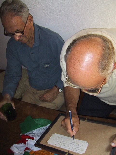 two people at a table doing soing on paper