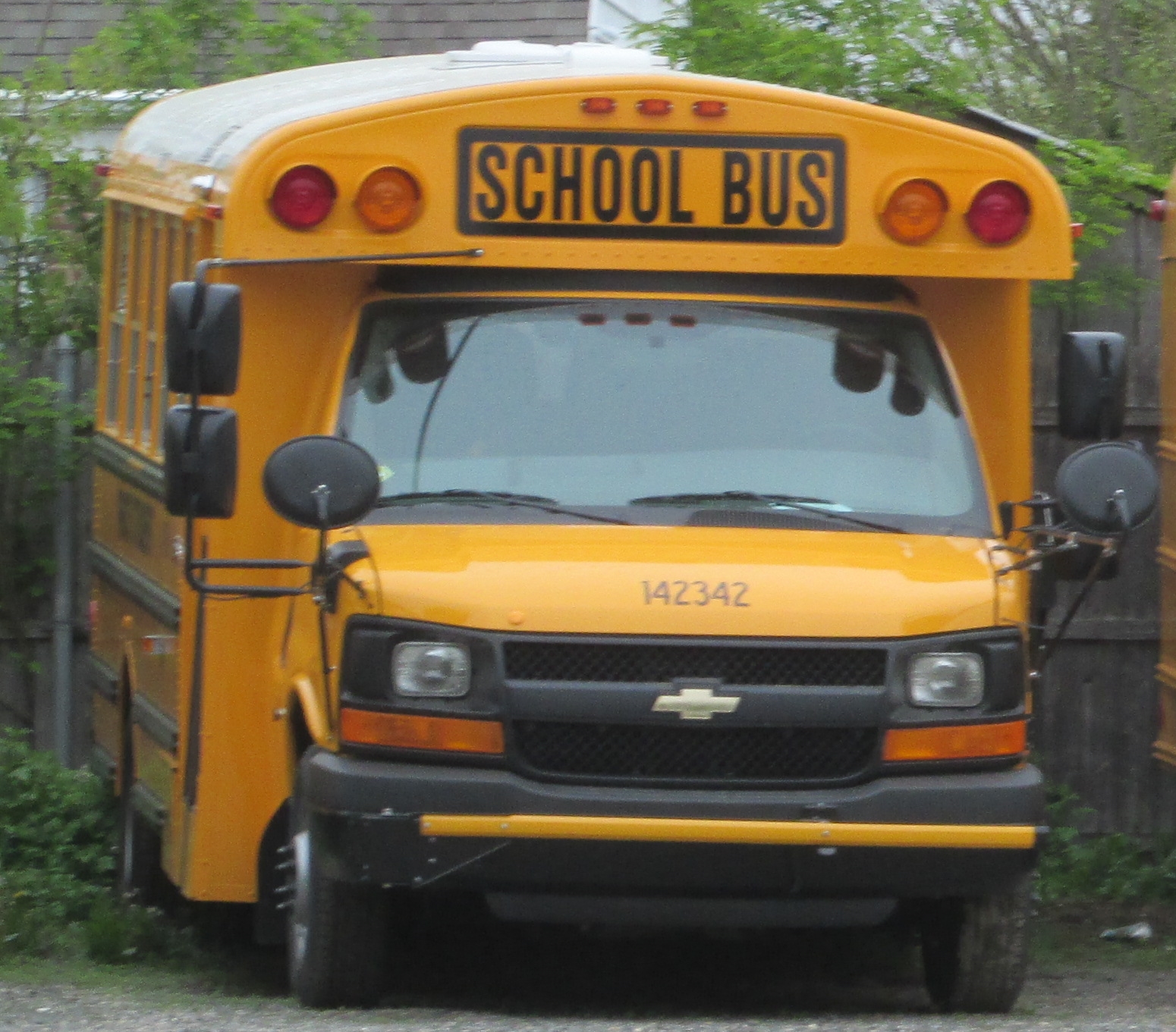 a yellow school bus parked on the side of a road