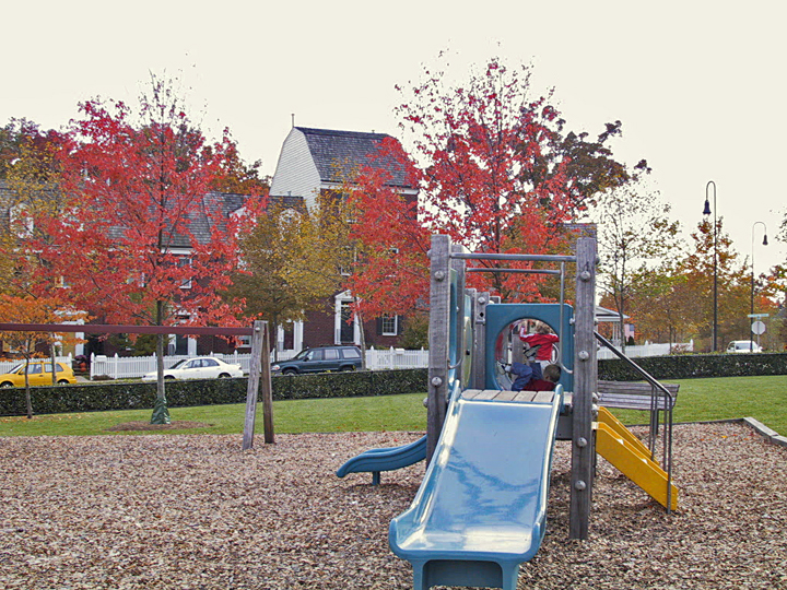 an empty playground and swings in the park