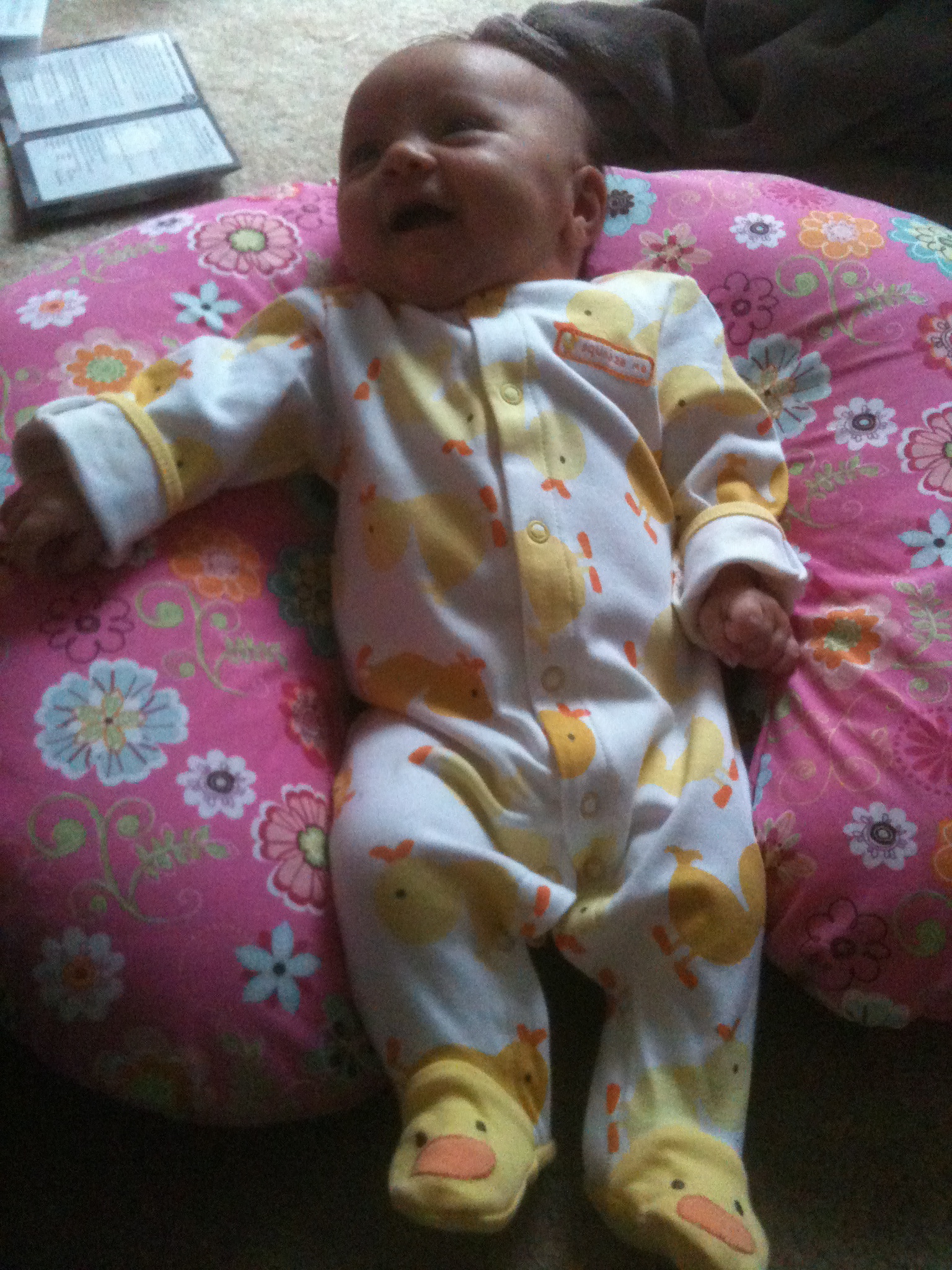 a baby laying on the floor in her play mat