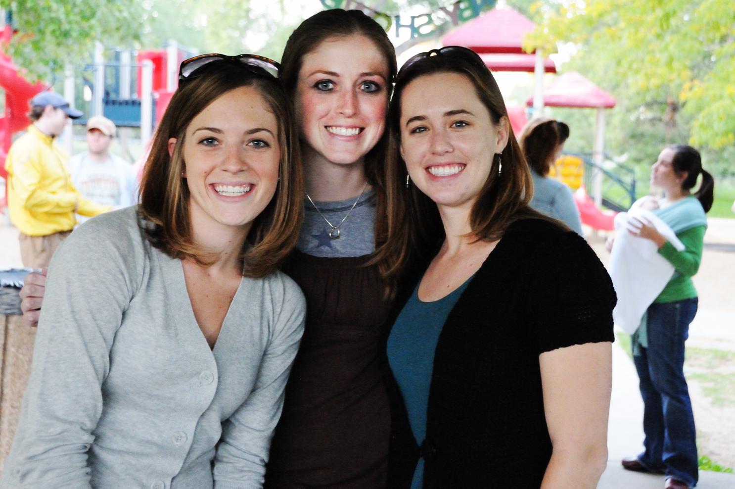 three women standing next to each other