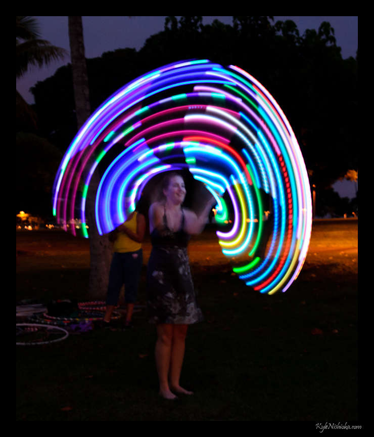 a woman holding a circular light painting