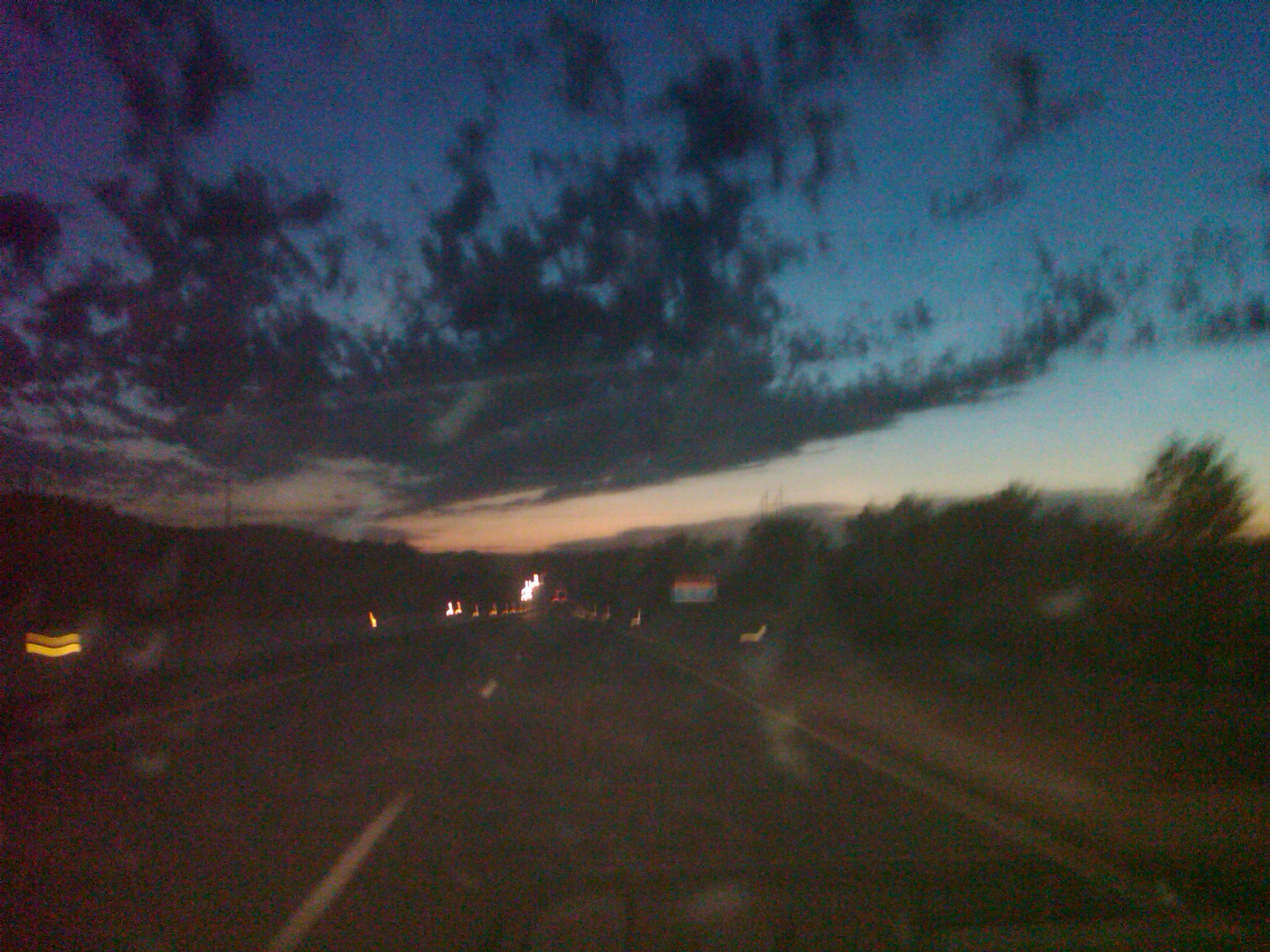 a blurry night scene taken through a windshield