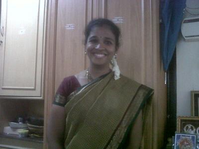 an indian woman is standing in her kitchen wearing a sari