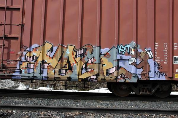 an image of a rail road track with graffiti