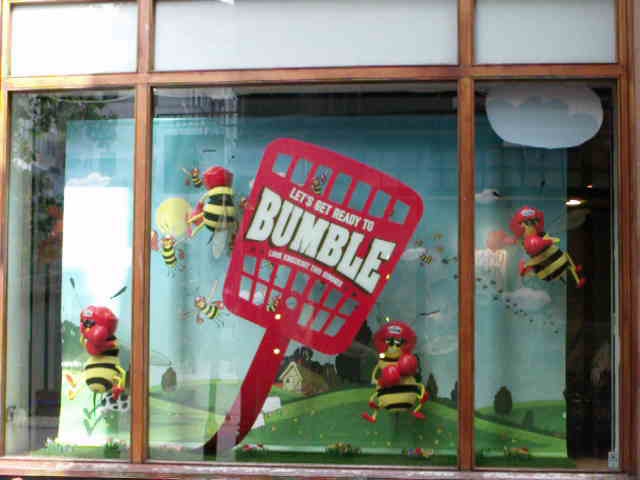 a window display with bumblebees in it