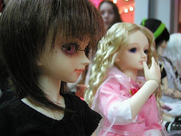 some dolls are looking at each other in the same room