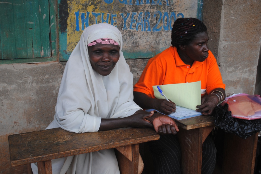 a woman in orange sits at a table with her friend