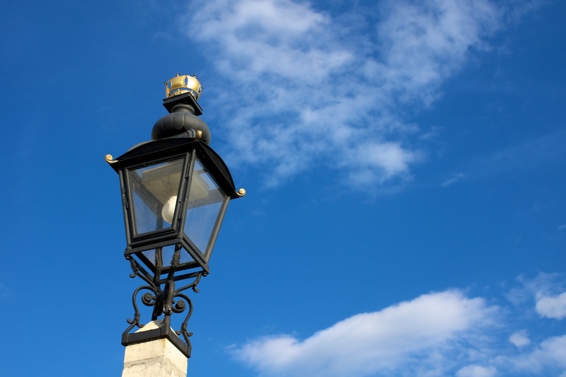 a very pretty street light with the blue sky behind it
