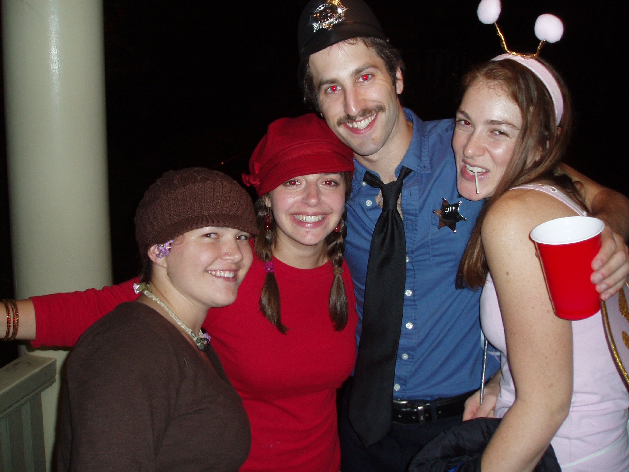 four friends dressed up pose together for the camera