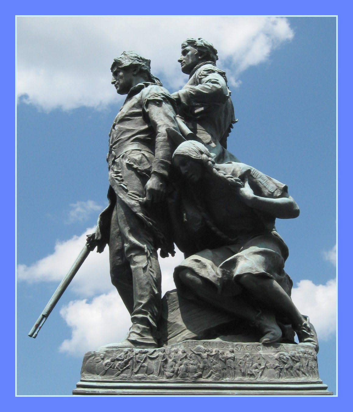 a statue with two men holding on to one