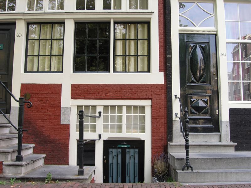 a building has a black door and glass windows