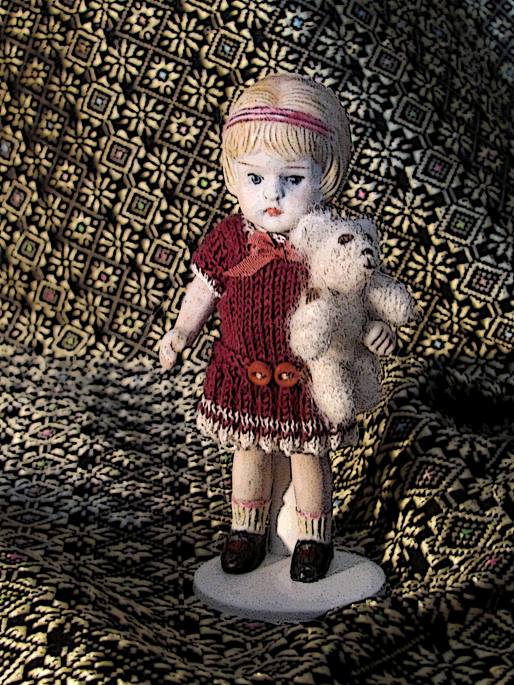 a doll and her stuffed teddy bear on a mosaic