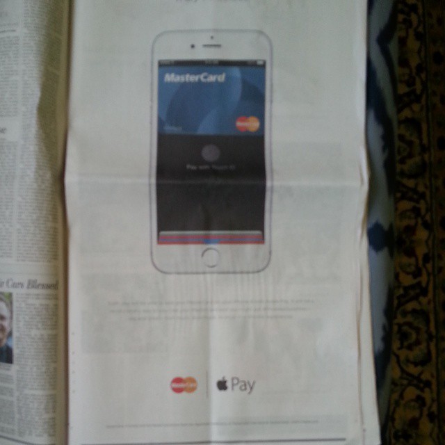 a newspaper article features a paper advertit for cell phone