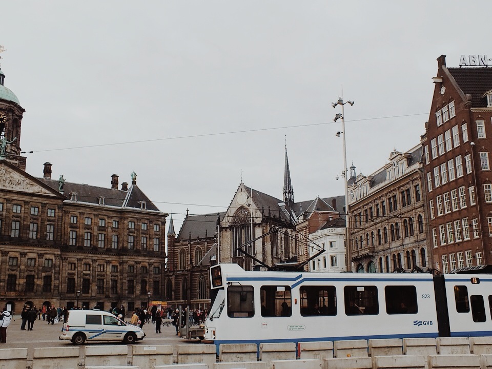 a train car is parked in front of a building and some buildings