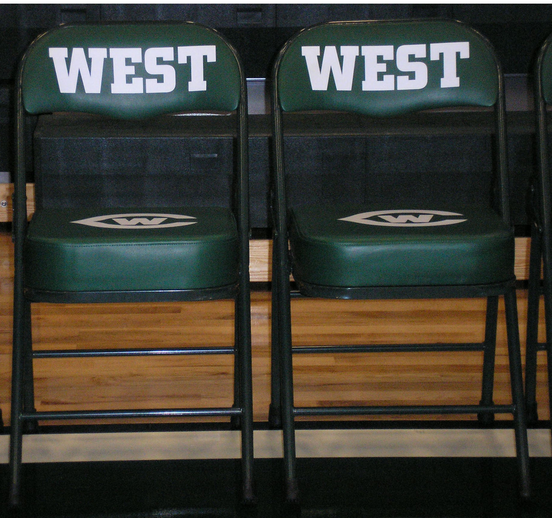 two chairs sitting side by side with the words west on them