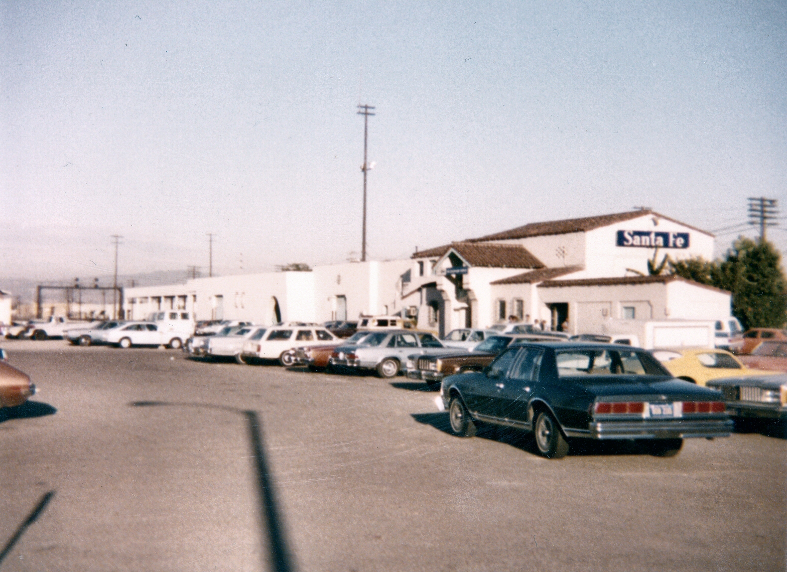 a row of cars parked in front of a store