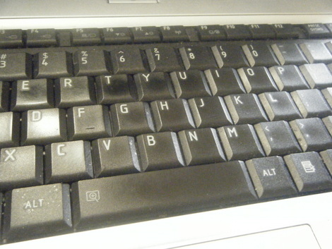 a keyboard sitting on top of an apple laptop computer