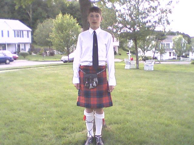 a man wearing a tie and kilt