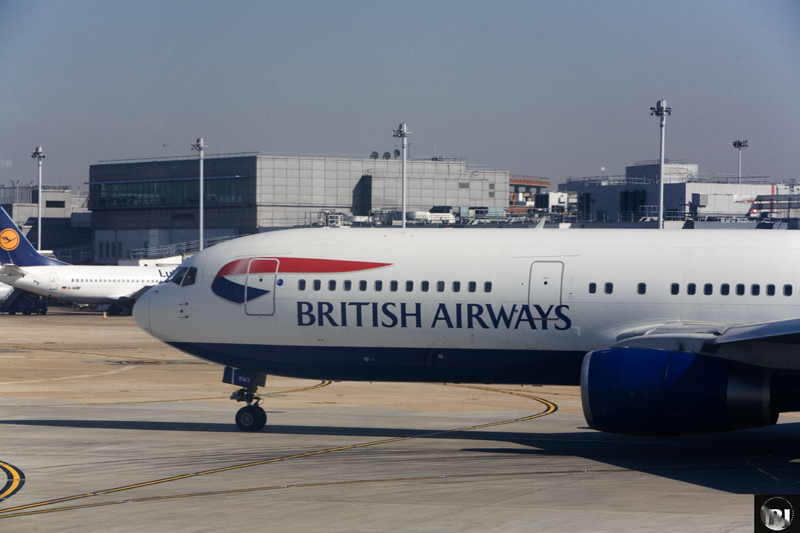 a passenger jet parked at an airport loading passengers