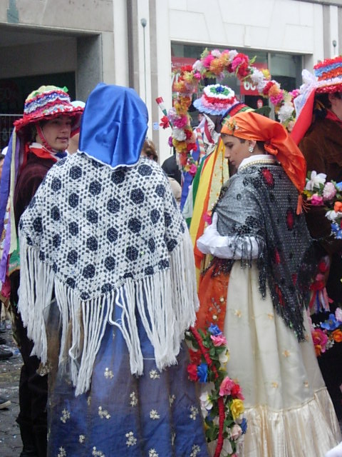 group of women dressed in costumes standing in the street