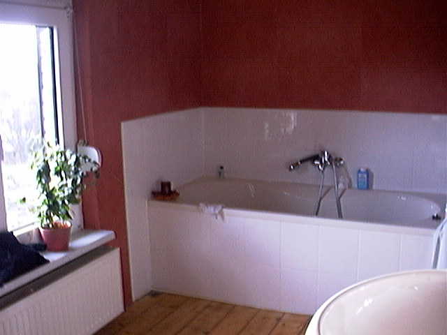 a tub and a window in a bathroom