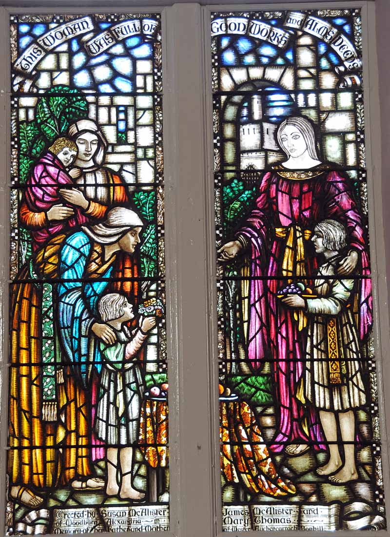 a stained glass window showing a woman and child