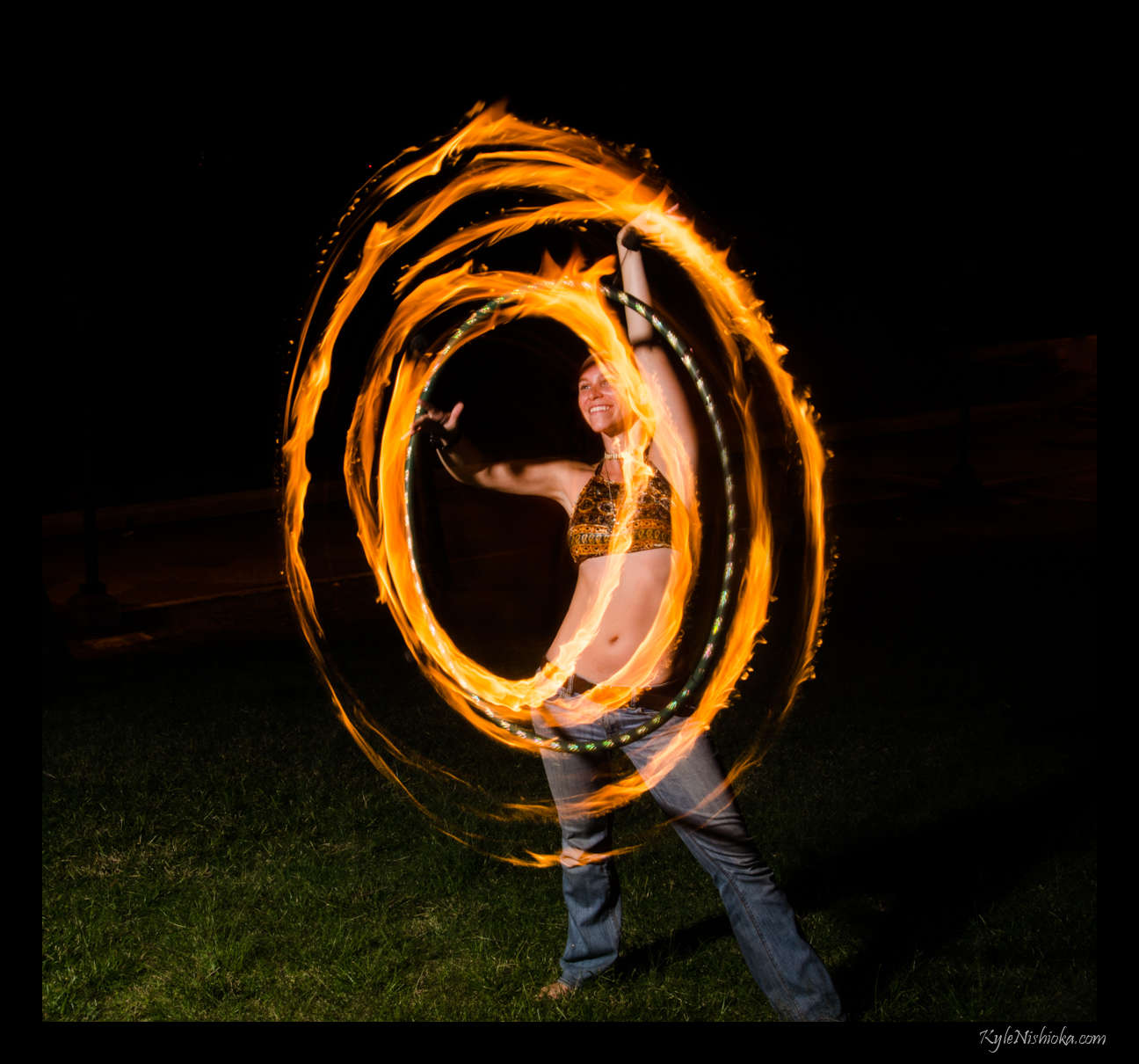 a man spinning his fire in the air