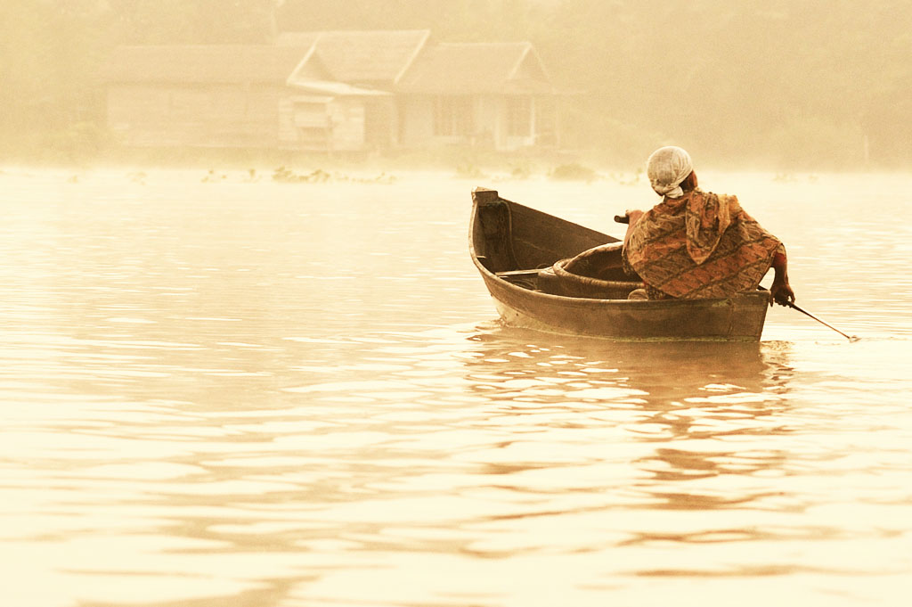 a person in a boat on a lake