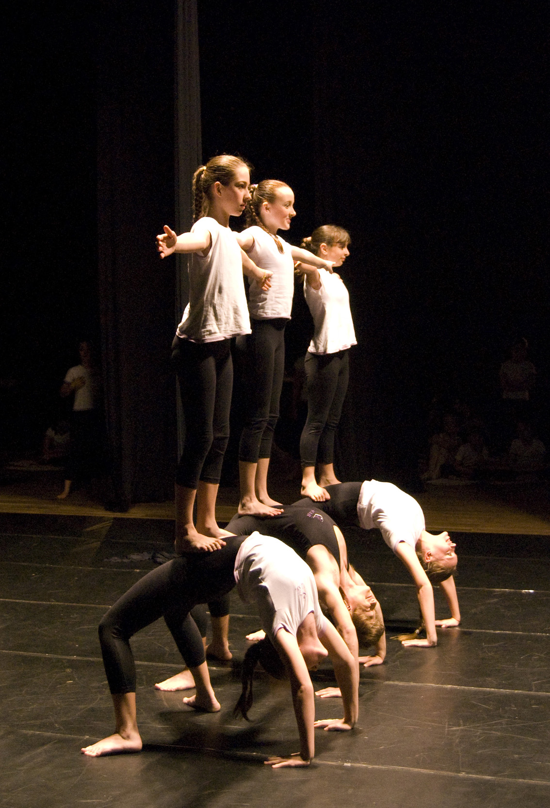 a group of people in tight clothing performing a move