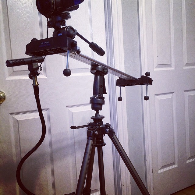 a black video camera set up on a tripod