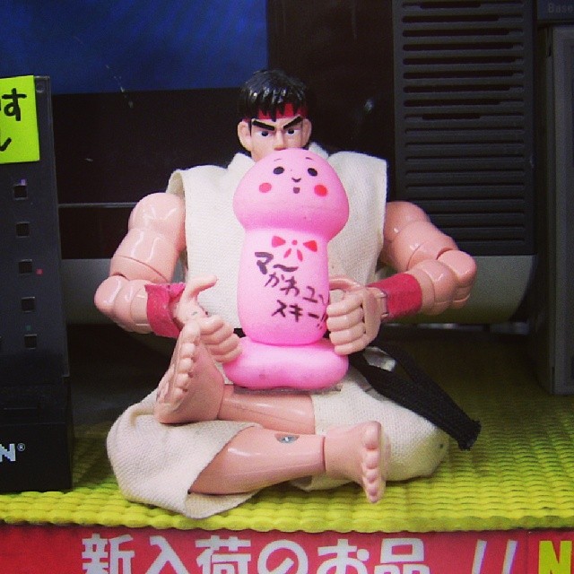 a toy of an asian person holding a bottle