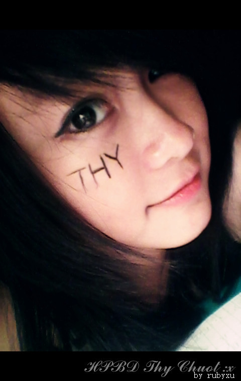 a woman with the words x and y painted on her face
