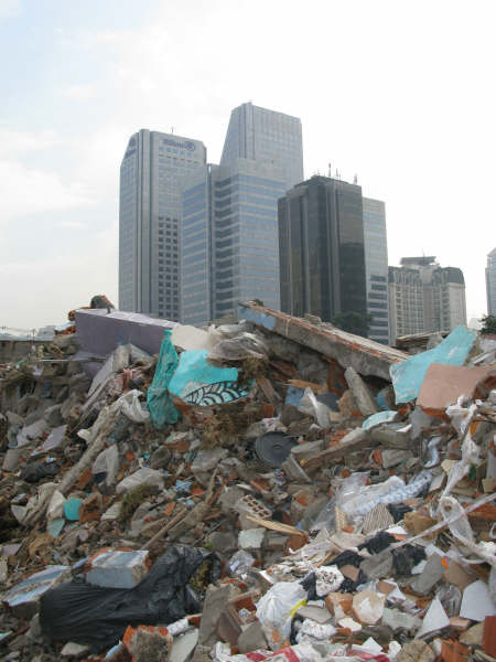 a large pile of garbage with a skyline in the background