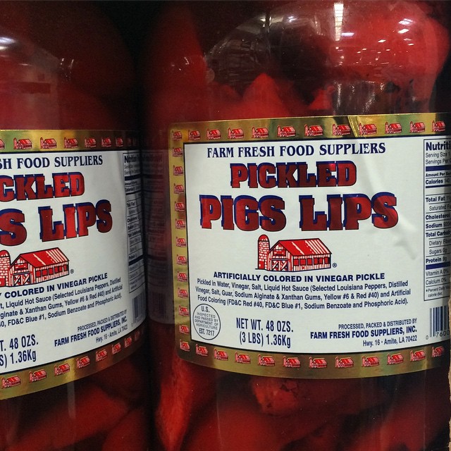 several jars of pickled pigslips sit on the shelves