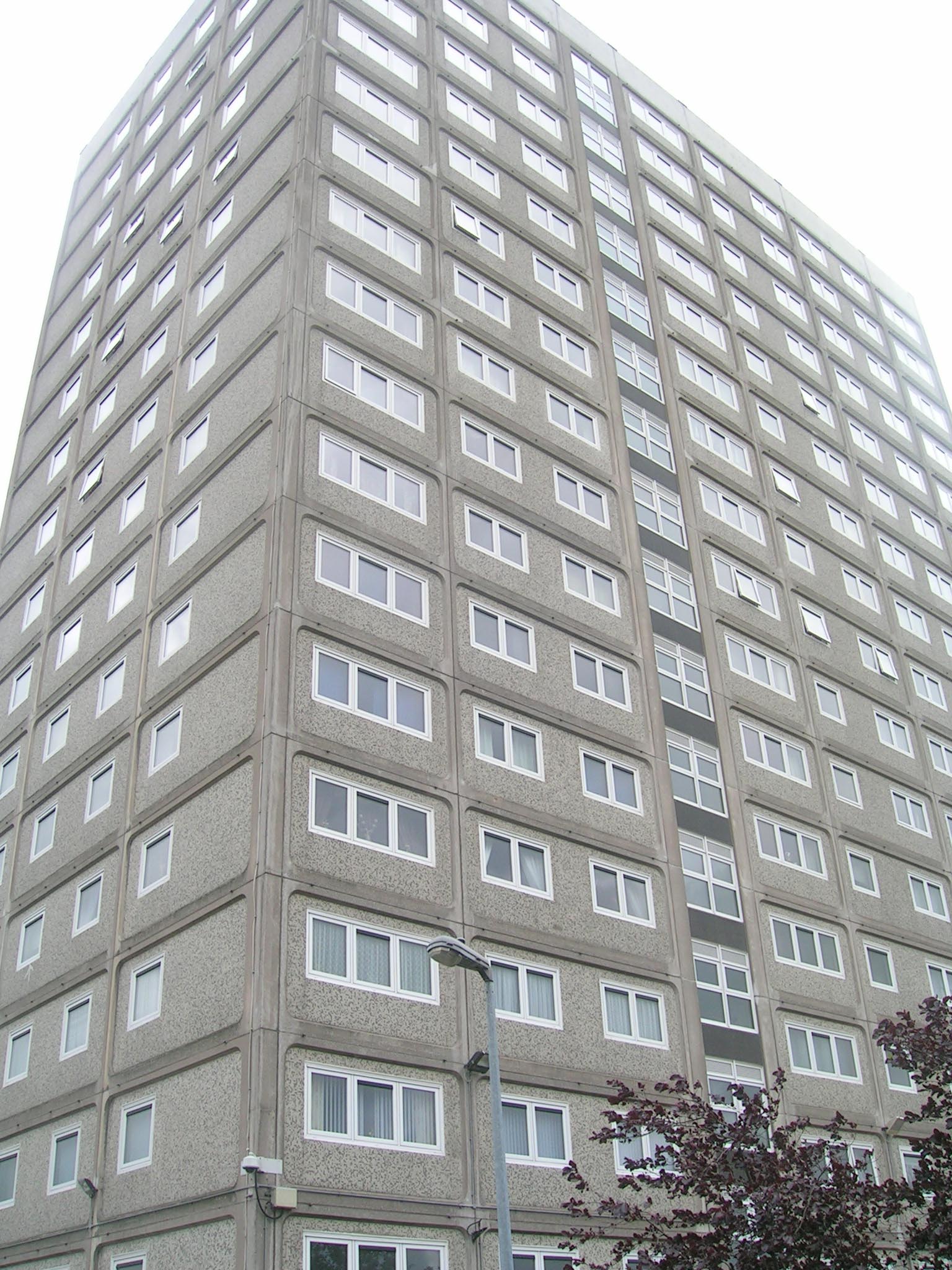 a very tall grey building with lots of windows